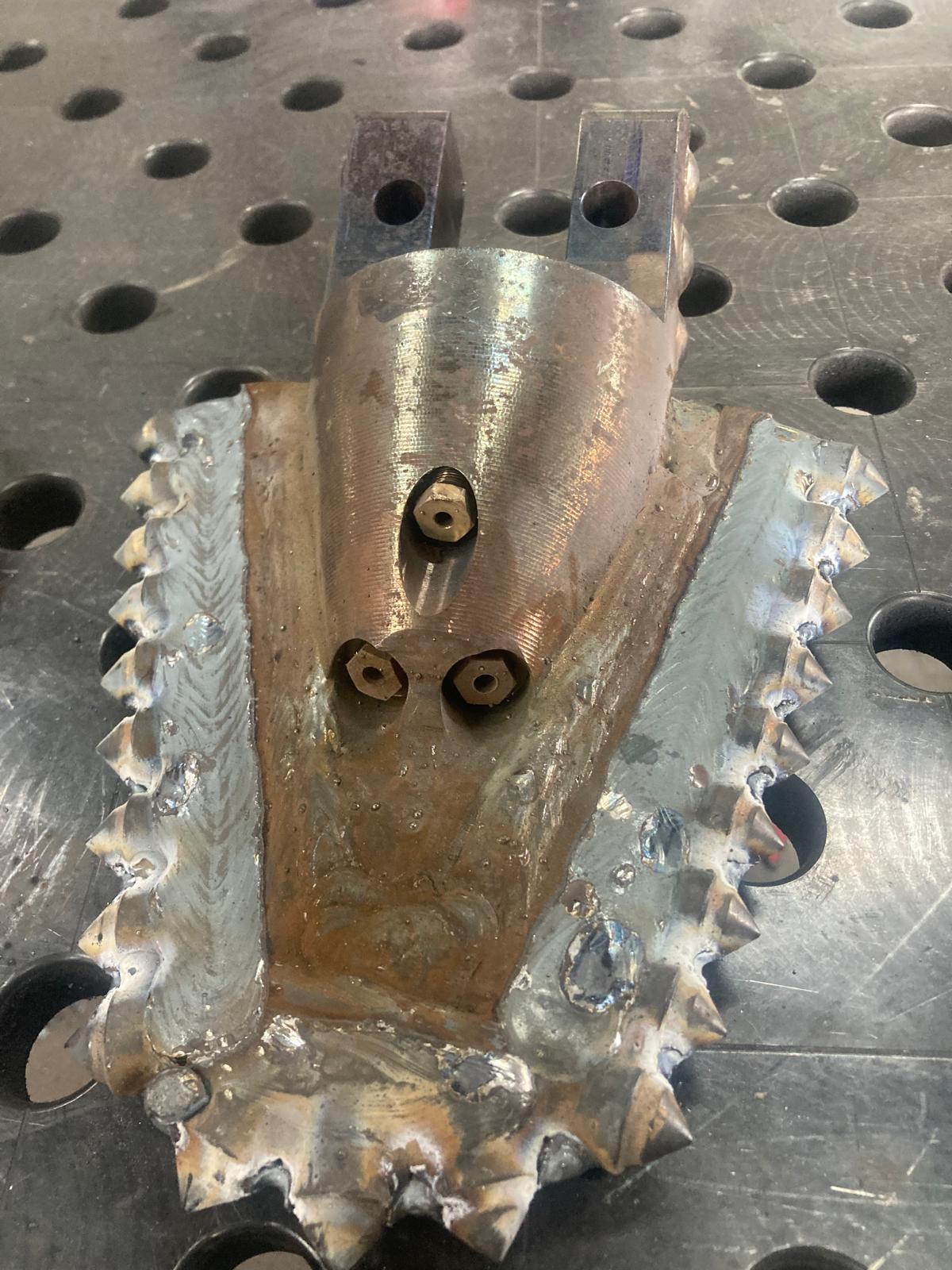 Modified drill bit with extra nozzle and new cutting teeth
